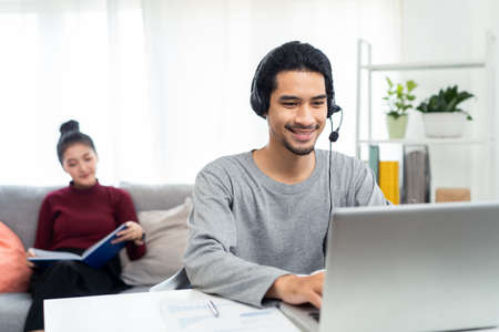 Asian businessman talking to colleague team in video conference. Man using computer laptop for...