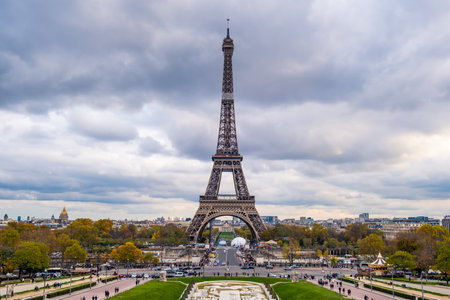 Eiffel tower in cloudy sky day in afternoon. The most famous tourist landmark in Europe. Behind Eiffel tower is city center, downtown in Paris, France.の写真素材