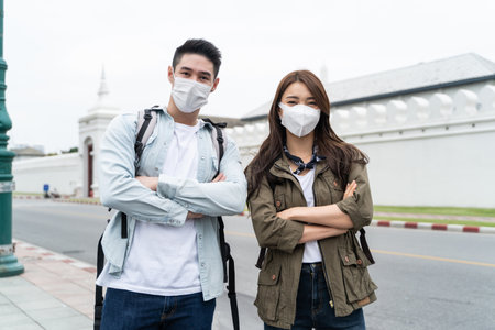 Portrait of Asian couple wear mask, travel in city for honeymoon trip. New marriage man and woman...