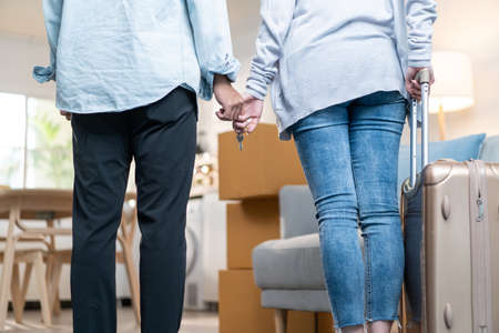 Close up hands of new marriage couple holding new house key together. Young attractive romantic man...