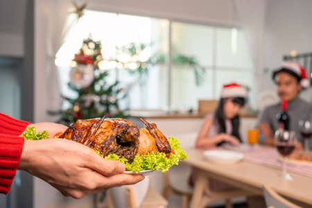 Asian lovely family member celebrate christmas party together in house. Young little daughter feel...