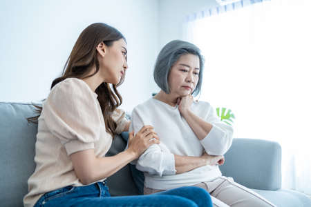 Asian loving daughter comforts upset elderly mother crying for problem. Young caring woman support,...