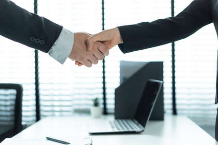 Close up of handshake with hr manager after job interview in office. Business employee people doing...