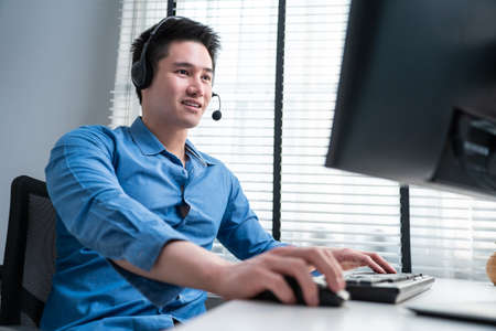 Asian handsome business man using laptop computer working in office. Attractive professional male...