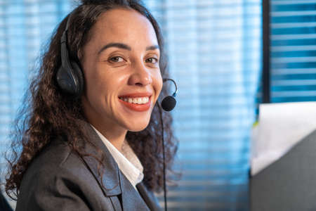 Portrait of Latino beautiful business woman smile while work in office. Attractive professional...