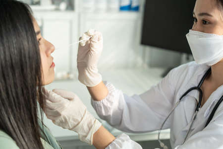 Close up of Asian specialist doctor diagnosis PCR Coronavirus sample. Young researcher using a rapid...