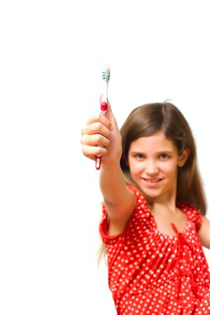 Beauty teen girl show toothbrush isolated on whiteの写真素材
