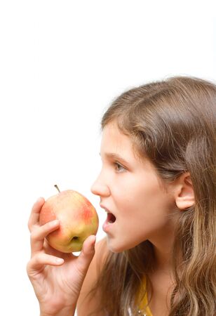 Teen girl eat apple isolated on white for your designの写真素材
