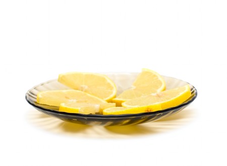 Lemon slices on plate isolated on whiteの写真素材