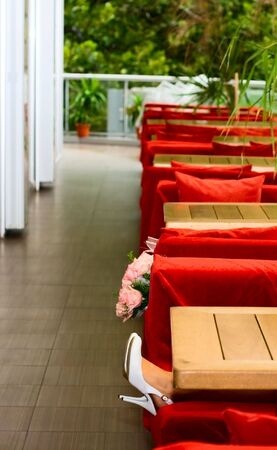 Feet in shoes bride girl and roses in cafeの写真素材