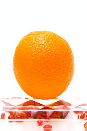 Orange and medicine capsules isolated on whiteの写真素材