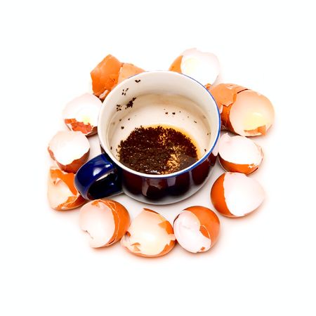 Cup with weak tea and shells isolated on white