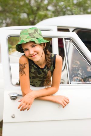 Teen girl in white carの写真素材