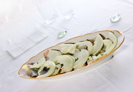 Salted fish and onion on plateの写真素材