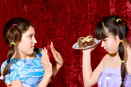 Two Lovely teen girls with cakeの写真素材