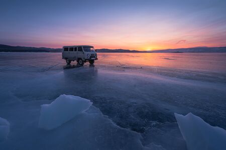 Russian van on Baikal froaen lake at sunset in winter season, Siberia, Russia, Asiaの写真素材