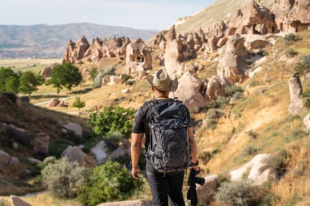 A photographer looking to Zelve open air museum in Capadocia plateau, central Anatolia, Turkey, Asia