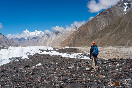 A trekker looking to Paiju mountain peak in K2 base camp trekking route, Karakoram mountain range in...
