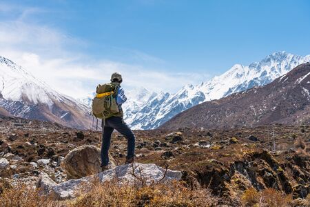 Young Asian woman trekker with backpack trekking in Langtang valley, travelling in Himalaya...