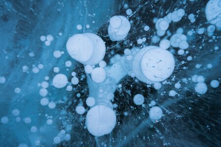 Methane Bubbles in frozen lake Baikal in winter season, Siberia, Russia, Asia. Background and...