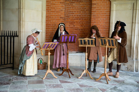 Traditional Musicians wearing medieval clothes perform at Hampton Court Palace near Londonのeditorial素材