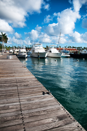 Scenic view of a variety of pleasure boats, motorboats and yachts moored in a marine harbor in Oranjestad, Aruba in the Caribbean under a dramatic cloudy blue skyのeditorial素材