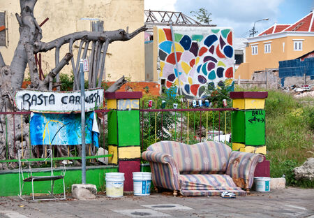 Curbside Rasta Car Wash with Sofa and Buckets in Residential Neighborhoodのeditorial素材