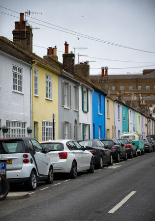 Car Parking on Street Side Fronting Assorted Colors Houses.のeditorial素材