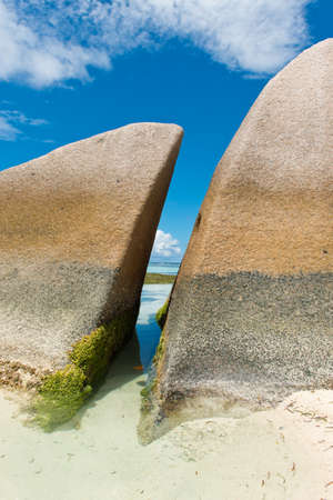 Algae on Historic Huge Rocks, with Blue and White Sky Background, at Anse Source d'Argent Lagoon. Located in La Digue Island, Seychelles.の写真素材