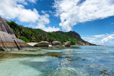 Beautiful Natural View of Anse Source d'Argent with Rocks and Mountains on the Beach Side at La Digue. A Tourist Destination in Seychelles.の写真素材