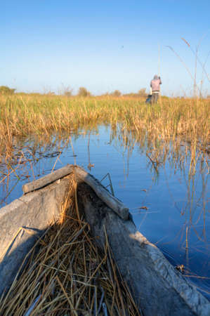 Boat and fishermen at a riverの写真素材