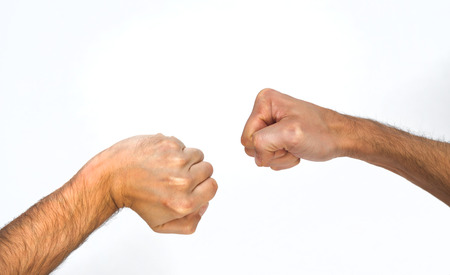Two orientations of a man clenching his fist, one sideways and one viewed from overhead with a bent wrist, close up view of the arm isolated on whiteの写真素材