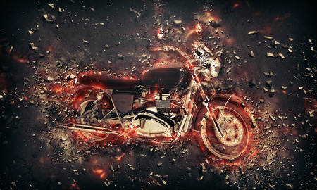 Fiery burning motorbike conceptual image with flames erupting from the wheels and frame depicting extreme sport, speed and danger over a dark backgroundの写真素材