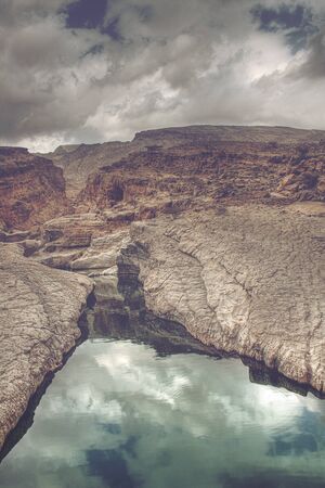 Clouds Reflected in Waters of Wadi Bani Khalid Running Through Rocky Canyon, outside of Muscat, Omanの写真素材