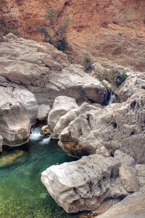 High Angle of Wadi Bani Khalid Waterfall in Rocky Canyon Outside of Muscat, Omanの写真素材