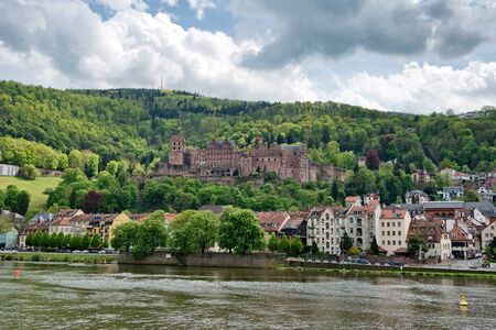 View of Heidelberg Castle and Town on the Banks of Neckar River, Surrounded by Lush Forested Hillsides, Heidelberg, Baden-Wurttemberg, Germanyの写真素材