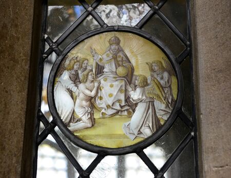 Close Up of Religious Themed Artwork Embedded in Window - Architectural Detail of Spiritual Worship Circular Artwork at Kings College, University of Cambridge, Englandのeditorial素材