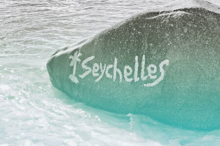 Close up Vintage Large Rock on Water at Beautiful Anse Lazio Beach in Praslin Island, Seychellesの写真素材