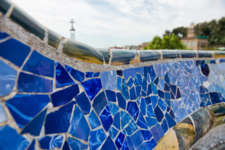Detail of bright blue ceramic mosaics on the curving wall on the main terrace, Parc Guell, Barcelona, Spain, designed by architect Antoni Gaudi and a Unesco world Heritage Siteのeditorial素材