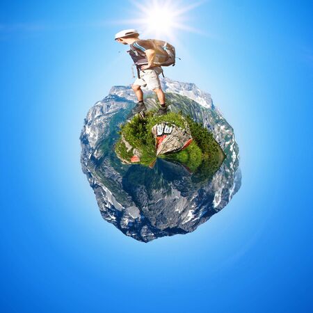Male Hiker Treading on Abstract Fish Eye Mountain Globe Scenic Under Bright Sunlight - Concept...
