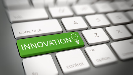 Innovation and originality concept with white text - Innovation - and a light bulb icon on a green enter key on a white computer keyboard viewed at an oblique high angle with blur vignette for focusの写真素材