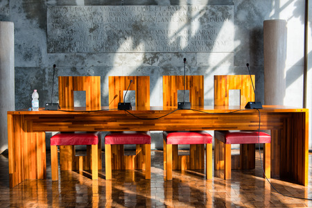 Modern Wooden Table and Chairs Illuminated by Bright Sunlight in Aula Baratto Room at Ca Foscari University of Venice, Italyのeditorial素材