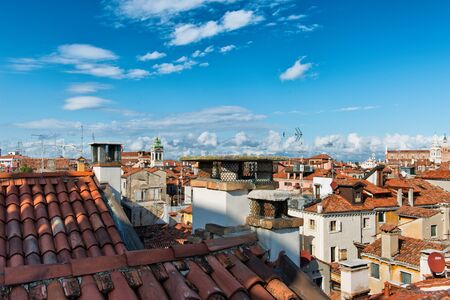 Aerial cityscape view over the rooftops and historic buildings of Venice, Italy with blue skyのeditorial素材