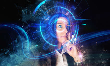 Blue and black glowing graphic of thinking business woman holding chin with cyber interface effect surrounding her eyeの写真素材