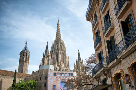 Low Angle View of Museu Diocesa and Gothic Spires of Barcelona Cathedral in front of Blue Sky with...
