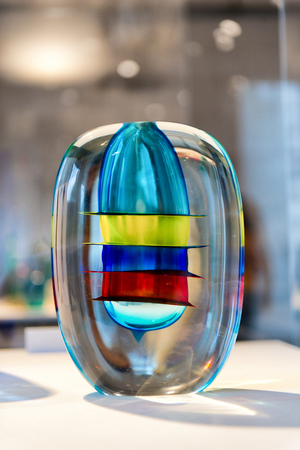 Colorful modern glass vase with interior bands of vivid color on display, Murano, Venice, Italyの写真素材