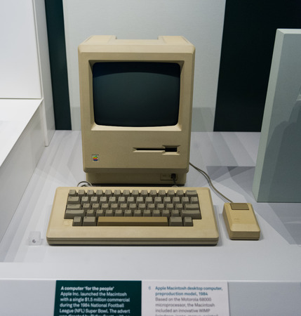 Old original Apple Mac computer with keyboard on display in a glass case in a museum, in London, UK,...