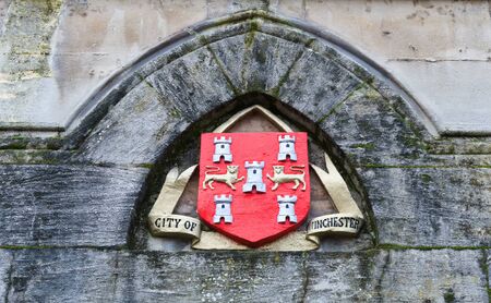 City of Winchester official seal in old mossy arch on building in the United Kingdomの写真素材