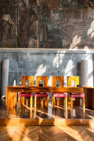 Modern Wooden Table and Chairs Illuminated by Bright Sunlight in Aula Baratto Room at Ca Foscari University of Venice, Italyのeditorial素材