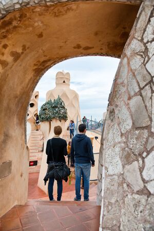 Full Length Rear View of Couple Standing Side by Side Admiring Gaudi Sculptures on Rooftop Terrace...